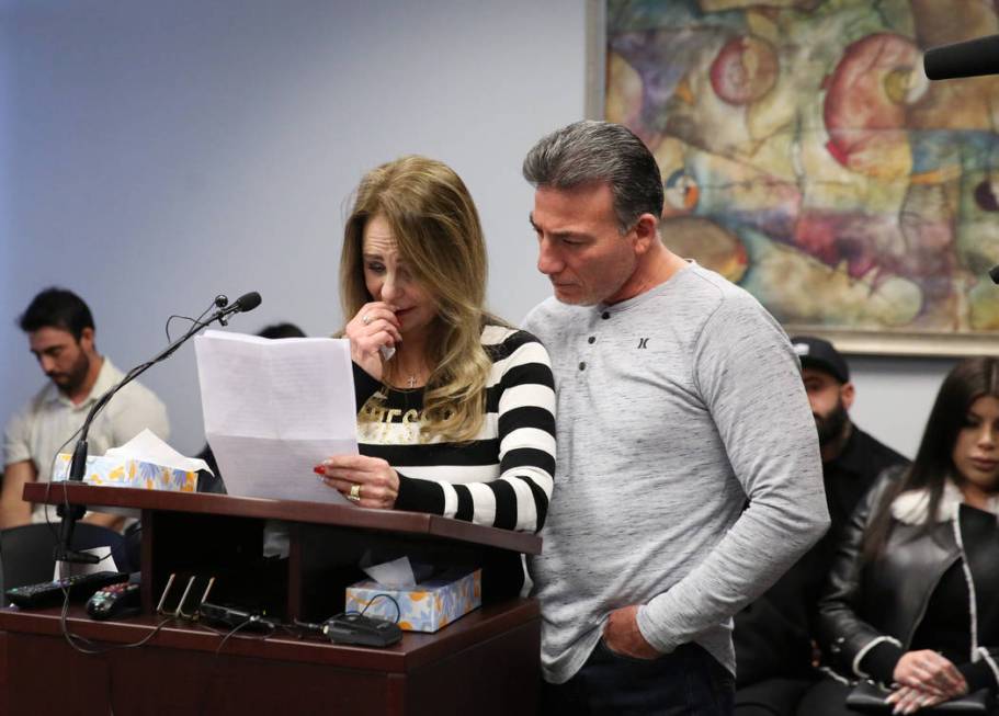 Saul Garibay comforts his wife Joyce, mother of 45-year-old Luis Campos, as she reads her state ...