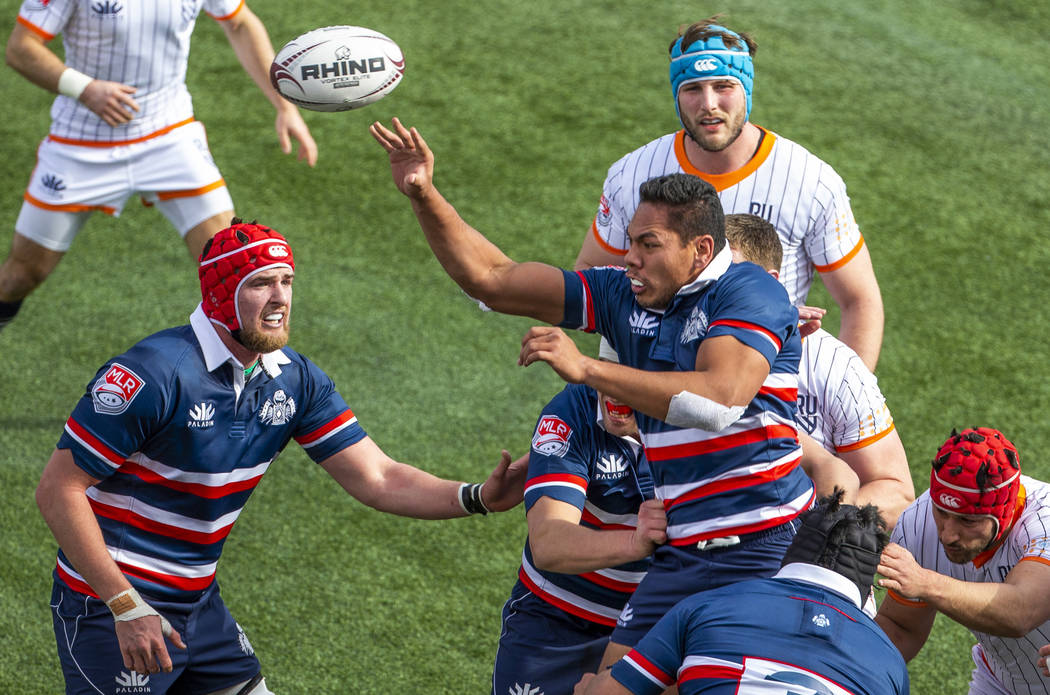 New England Free Jacks' Brad Hemopo (8, center) tosses the ball back to teammates after a throw ...