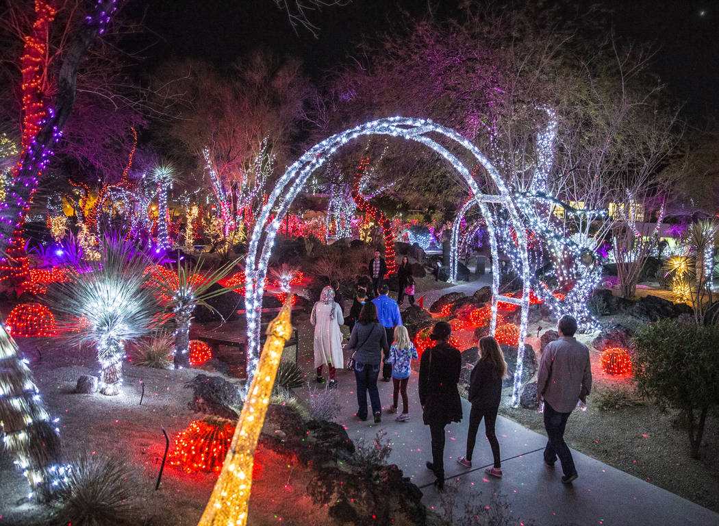 Attendees of the third annual Lights of Love take in the Valentine's Day-themed decorations at ...