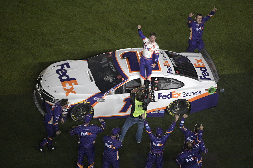 Denny Hamlin (11) celebrates in front of the grandstands after winning the NASCAR Daytona 500 a ...