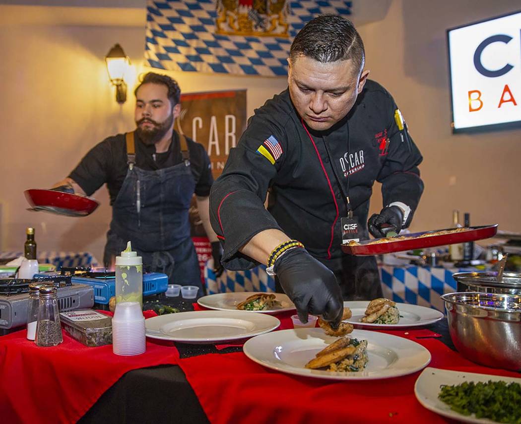 Chef Oscar Sanchez, right, Chef Battle Las Vegas winner, begins to plate his seared chicken dis ...