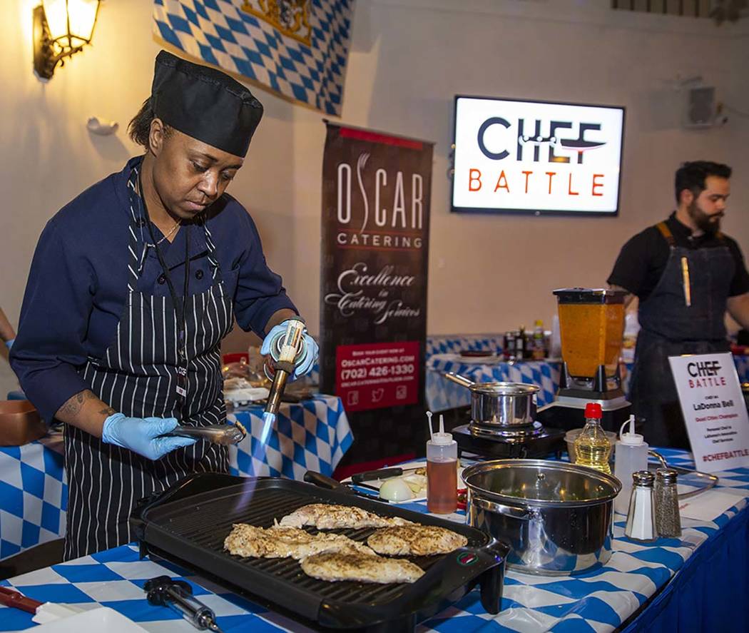 Chef LaDonna Bell, Chef Battle Quad Cities winner, braises some chicken during the All American ...