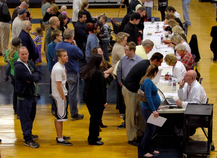 Voters wait to be check in at the voter verification station during the Republican caucus at Ce ...