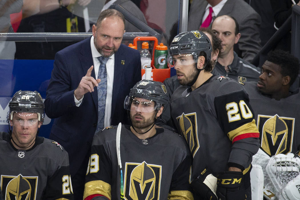 Golden Knights head coach Peter DeBoer talks with Vegas Golden Knights center Chandler Stephens ...