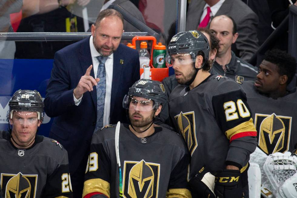 Golden Knights head coach Peter DeBoer talks with Vegas Golden Knights center Chandler Stephens ...