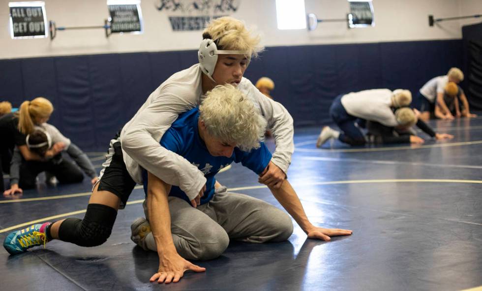 Sophomore Trent Smith, top, wrestles senior Triston Curtis, bottom, during wrestling practice a ...