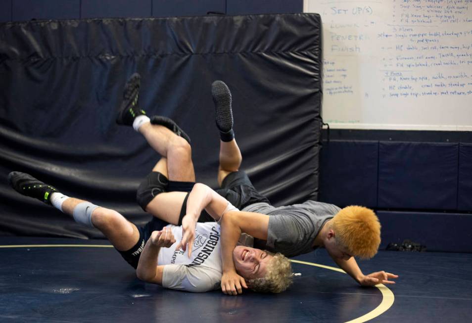 Senior Noah Gallardo, left, practices with his teammate, senior Joel Hemintakoon, during wrestl ...