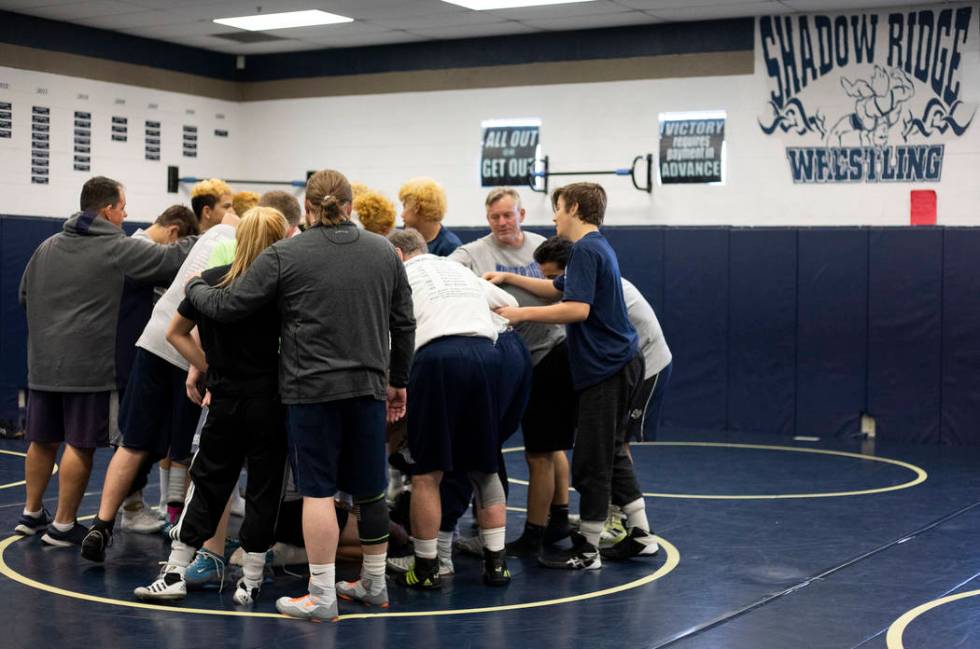 The Shadow Ridge High School wrestling team does a final chant after practice at Shadow Ridge H ...