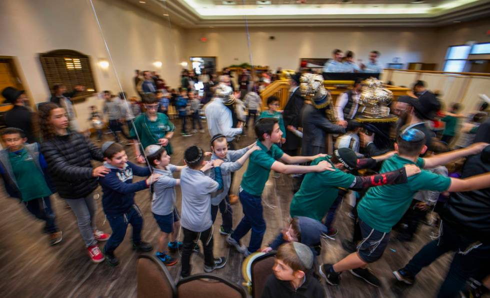 Chabad of Southern Nevada members dance with their new Torah and the three existing ones about ...