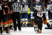 St. Louis Blues defenseman Vince Dunn, left, of center wipes his faces as Anaheim Ducks defense ...