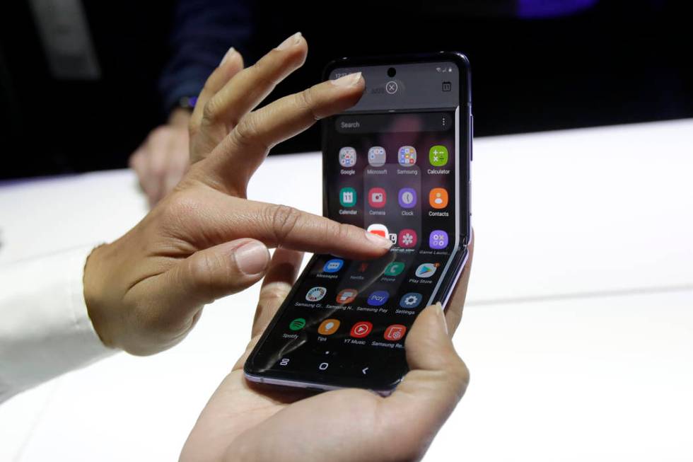 A Samsung worker gives a demonstration of the Galaxy Z Flip Phone at the Unpacked 2020 event in ...