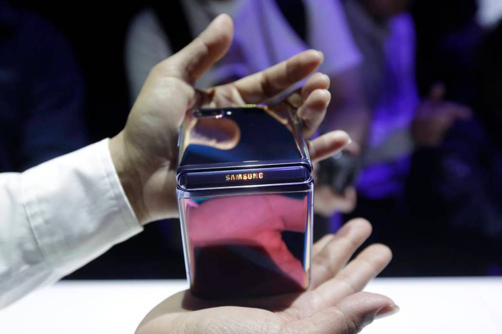 A Samsung worker gives a demonstration of the Galaxy Z Flip Phone at the Unpacked 2020 event in ...