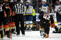 St. Louis Blues defenseman Vince Dunn, left, of center wipes his faces as Anaheim Ducks defense ...