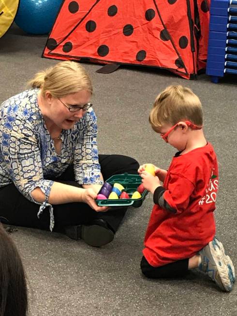 Emily Rawlings with Dynamic Music Therapy lets preschooler Levi pick a shaker during a music th ...