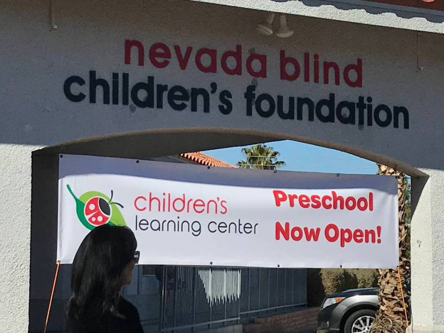 A ribbon cutting ceremony attendee walks Feb. 12 in front of the Nevada Blind Children’s Foun ...