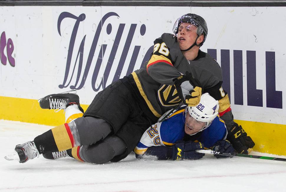 Vegas Golden Knights defenseman Nate Schmidt (88) collides with St. Louis Blues left wing Macke ...