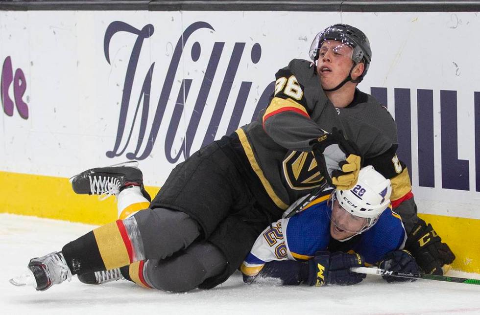 Vegas Golden Knights defenseman Nate Schmidt (88) collides with St. Louis Blues left wing Macke ...