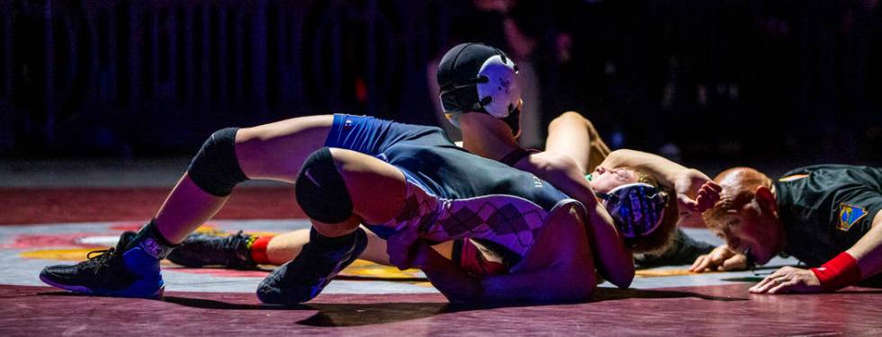 McQueen's Preston Harn, front, is close to being pinned by Cimarron-Memorial's Otto Cate-Cribar ...