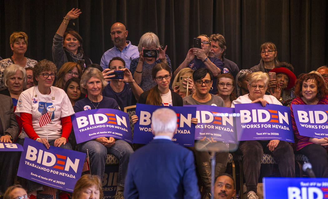 Former Vice President Joe Biden speaks to attendees sitting behind him during an early vote eve ...