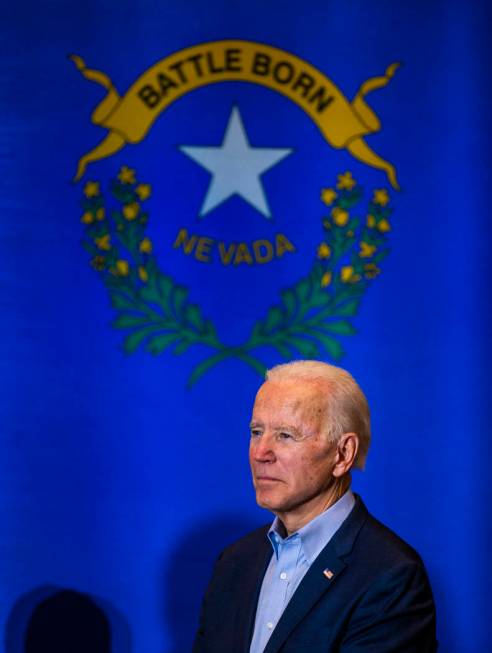 Former Vice President Joe Biden listens as U.S. Rep. Dina Titus, D-Nev., speaks during an early ...