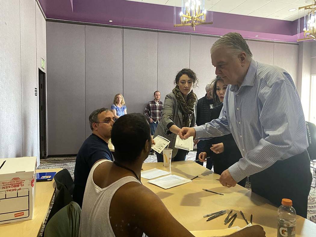 Gov. Steve Sisolak turns in his voting card on Saturday, Feb. 15, 2020. (Glenn Puit/Las Vegas R ...