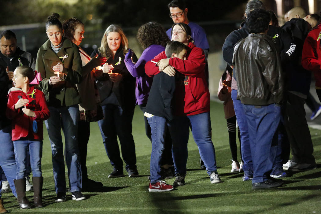 Dozens of parents and students hold candles during a candlelight vigil at Somerset Academy in N ...