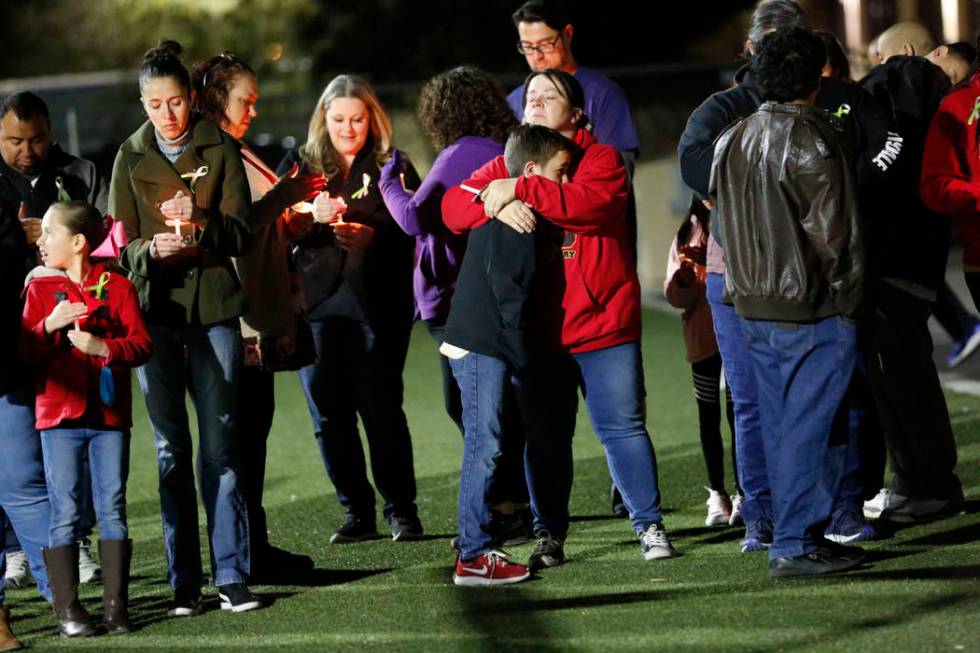 Dozens of parents and students hold candles during a candlelight vigil at Somerset Academy in N ...