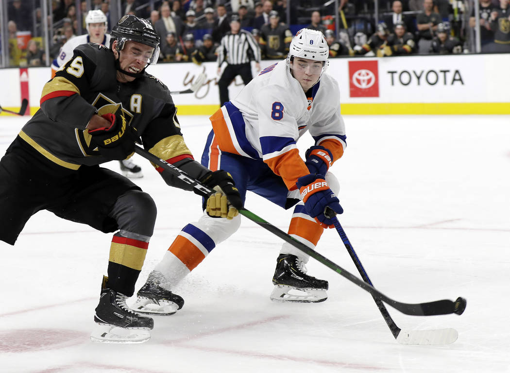 Vegas Golden Knights right wing Reilly Smith (19) shoots as New York Islanders defenseman Noah ...