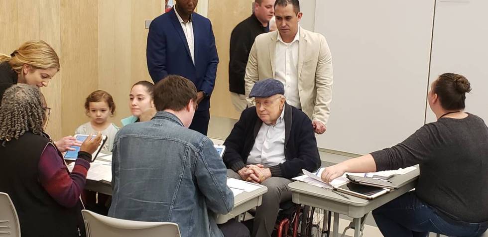 Former Senate Majority Harry Reid checks in with a volunteer at the Nevada State Democratic Par ...