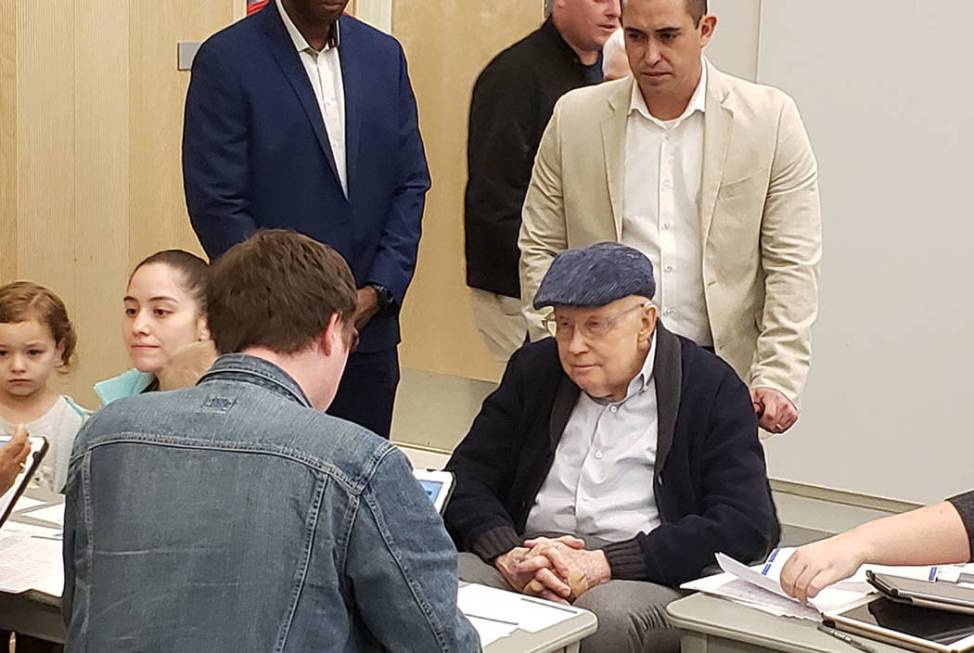 Former Senate Majority Harry Reid checks in with a volunteer at the Nevada State Democratic Par ...