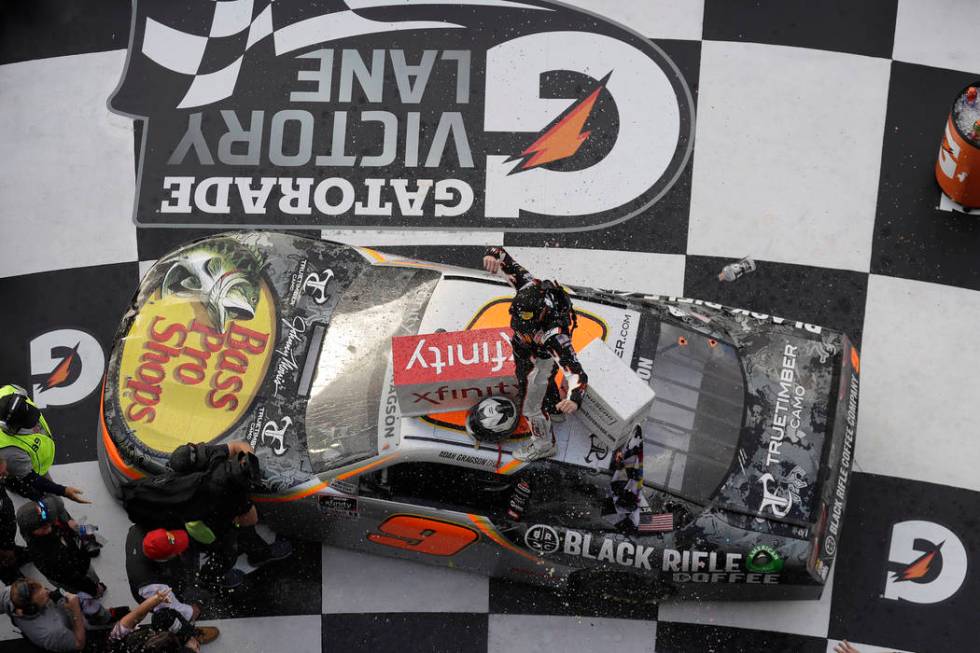 Noah Gragson celebrates on roof of his car in Victory Lane after winning the NASCAR Xfinity ser ...