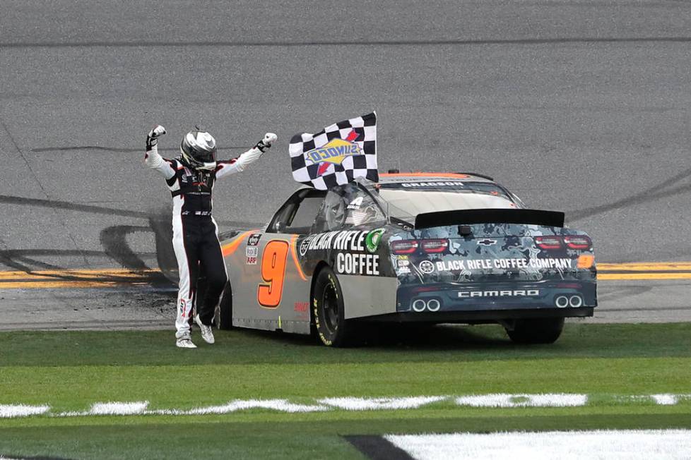 Noah Gragson celebrates in front of fans after winning the NASCAR Xfinity series auto race at D ...