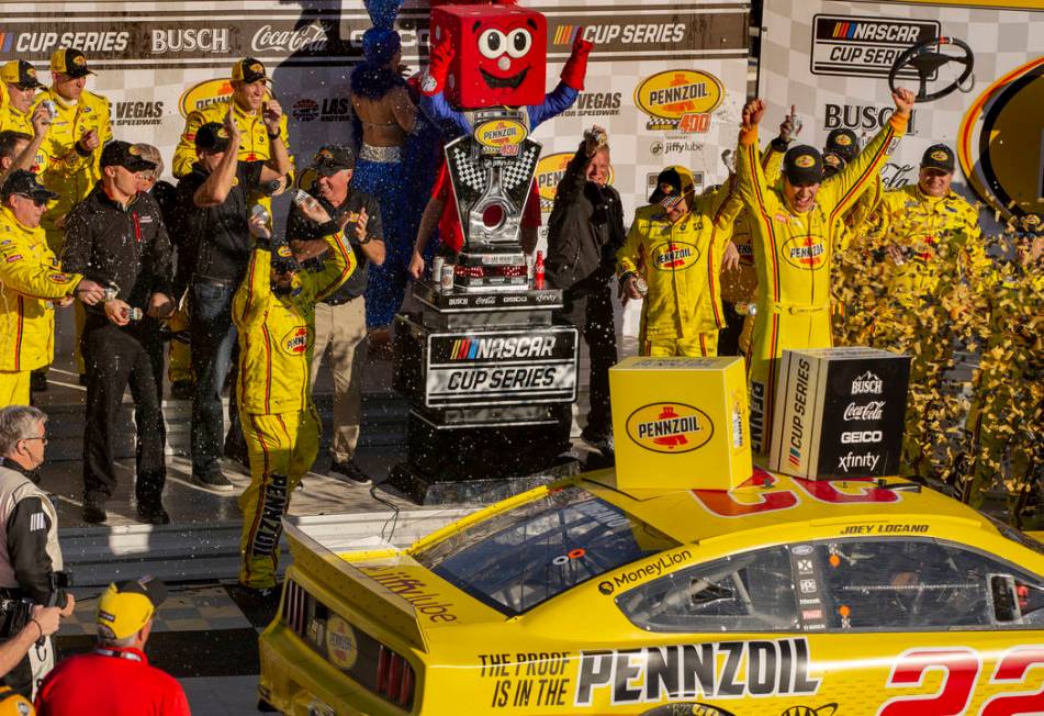 Joey Logano (22) and crew celebrate in the winner's circle following the Pennzoil 400 presented ...