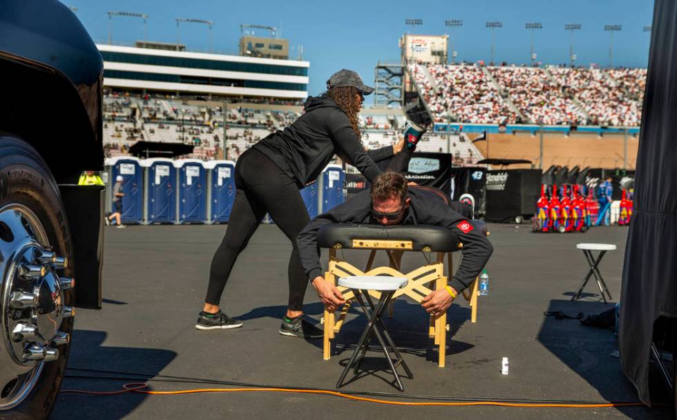 T.J. Ford receives a pre-race massage from Lindsay Jones of Novant Health in the garage area of ...