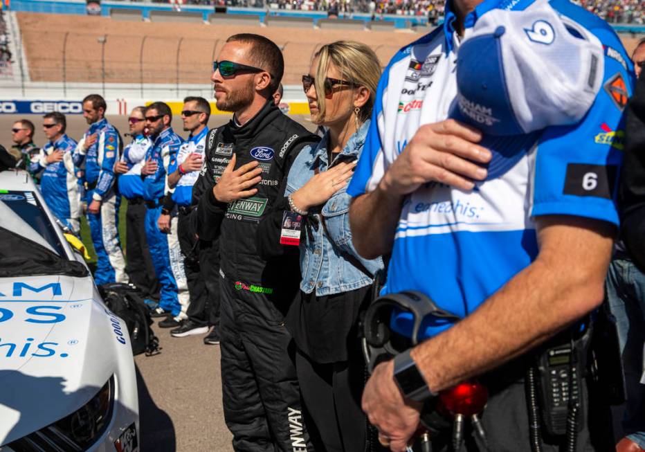 Ross Chastain (6, center) listens to the National Anthem with his crew before the start of the ...