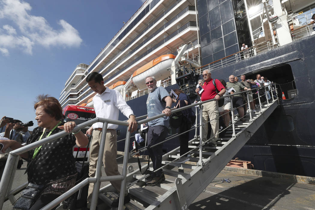 Passengers of the MS Westerdam disembark at the port of Sihanoukville, Cambodia, Saturday, Feb. ...