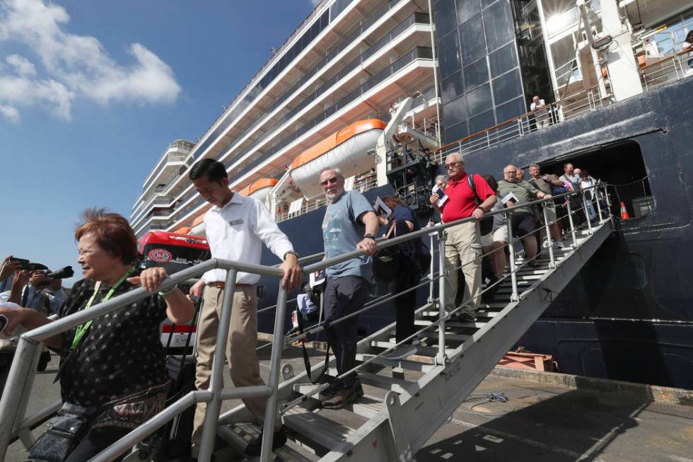 Passengers of the MS Westerdam disembark at the port of Sihanoukville, Cambodia, Saturday, Feb. ...