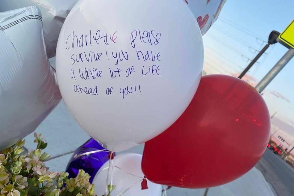 A memorial for a brother and sister hit by a truck on Friday, Feb. 14, 2020, sits next to a cro ...