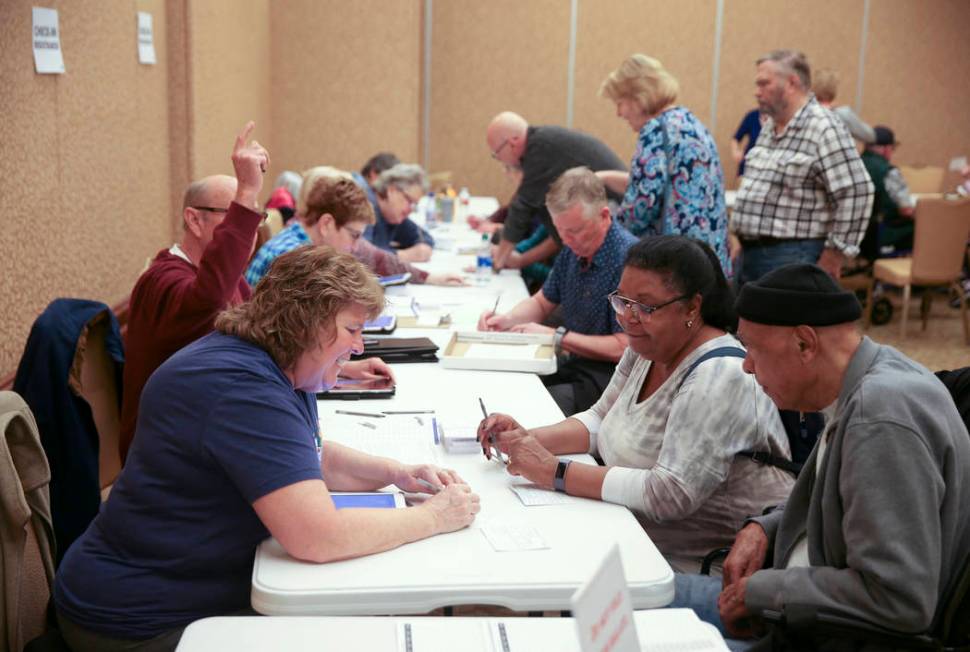 Volunteer Nancy Adams of Henderson, helps Phyllis Shurn-Hannah, 68, and her husband Edwin Hanna ...