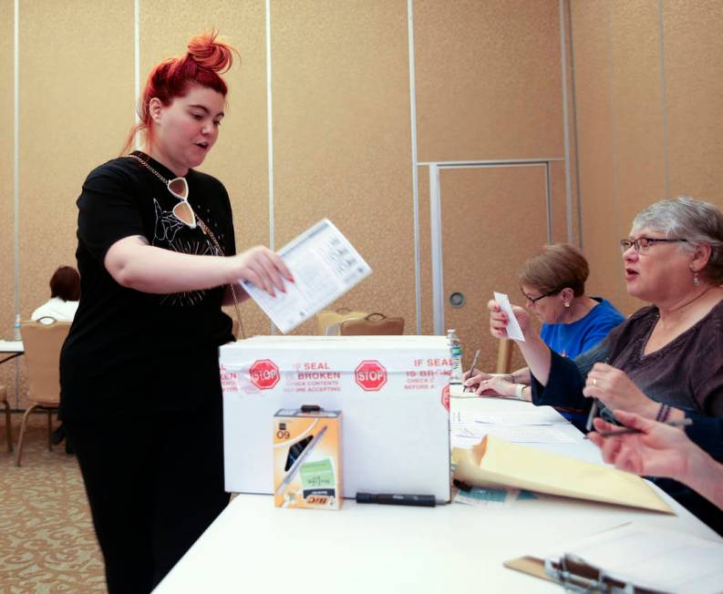 Whitney Vertucci, 27, of Henderson drops her ballot during early voting in the Nevada Democrati ...