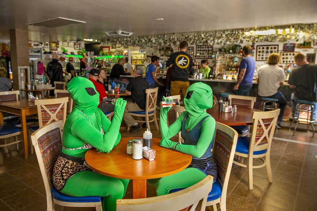 Invader Q-Tip, left, and Invader Stink enjoy a hot sauce breakfast at the Little A'Le'Inn Resta ...