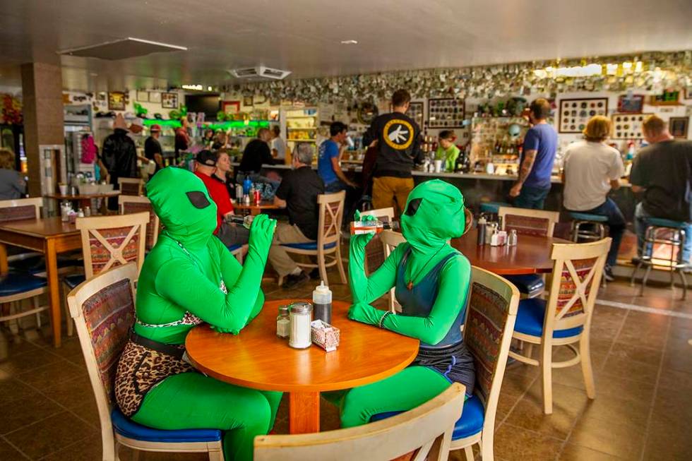 Invader Q-Tip, left, and Invader Stink enjoy a hot sauce breakfast at the Little A'Le'Inn Resta ...