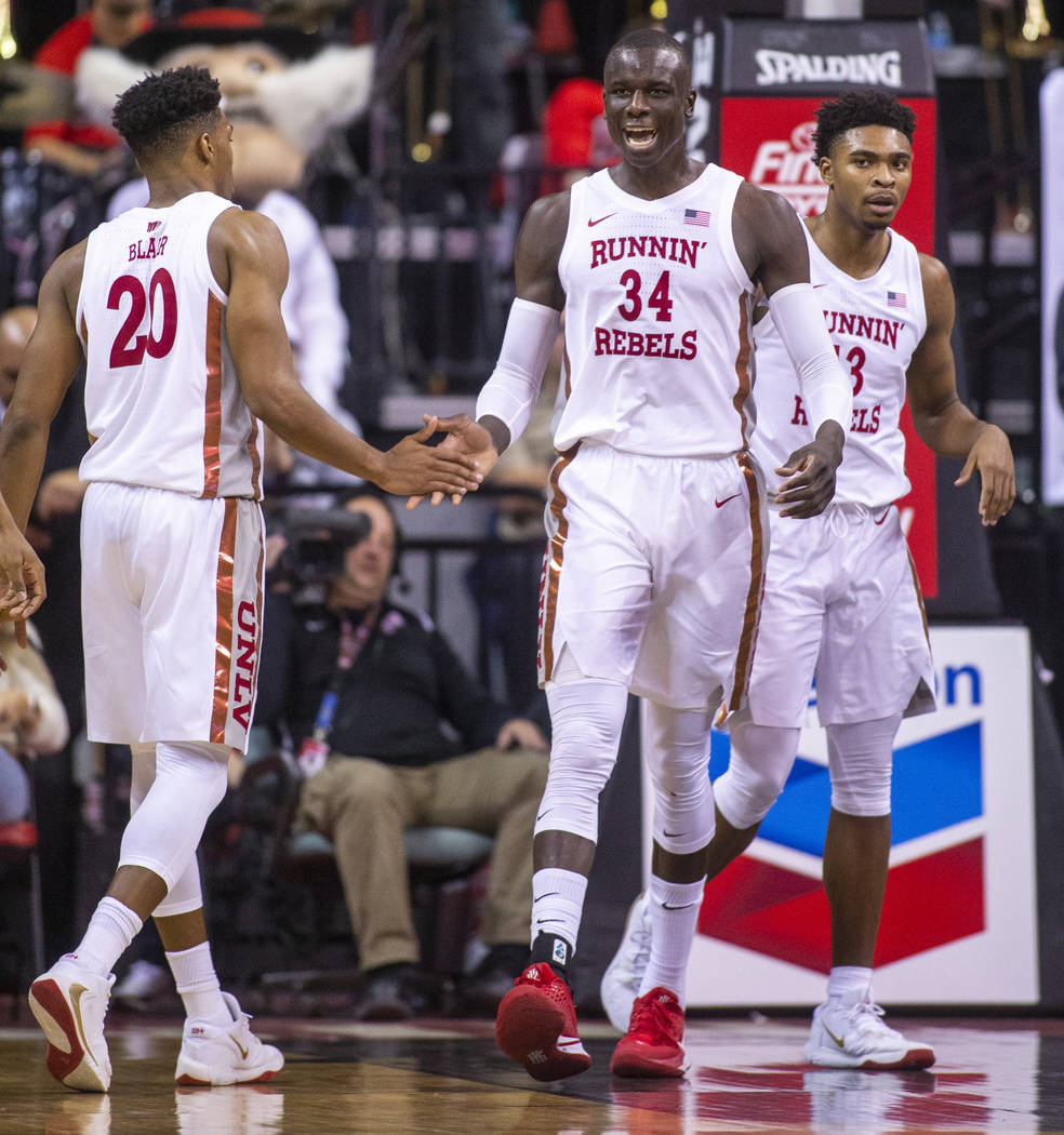 UNLV Rebels forward Nick Blair (20, left) congratulates teammate forward Mbacke Diong (34) on a ...