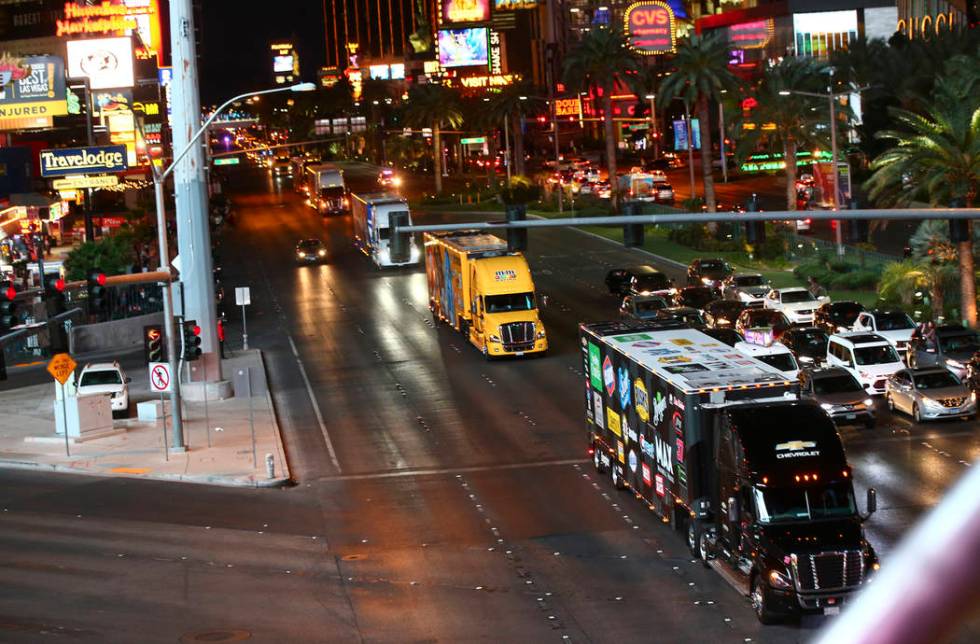 The haulers of Chris Buescher (37) and Kyle Busch (18) parade down the Las Vegas Strip near Har ...