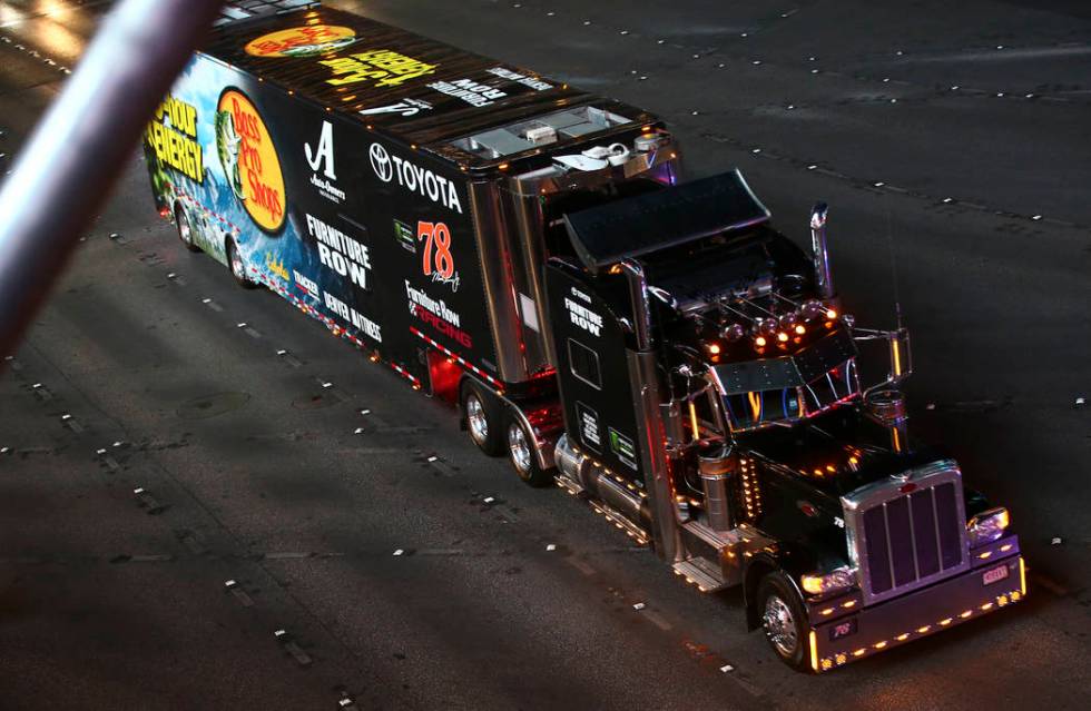 The hauler of Martin Truex Jr. (78) parades down the Las Vegas Strip near Harmon Road ahead of ...