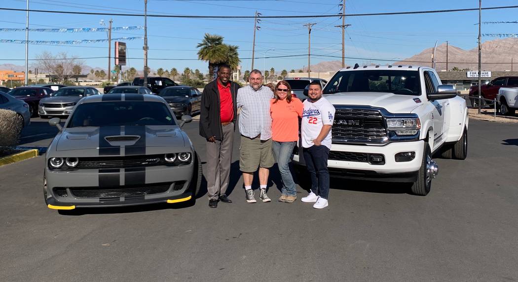 Sales Manager Jesse Aguirre, from left, Mitch Moore, Kristen Moore and Finance Manager Sanchez ...