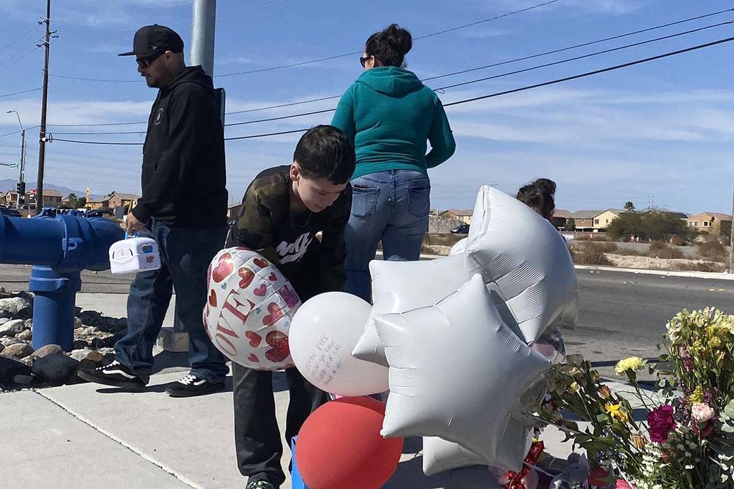 Aiden Maffett, 10, drops off a hockey and super hero box in memory of Alex Bush, 12, at a memor ...