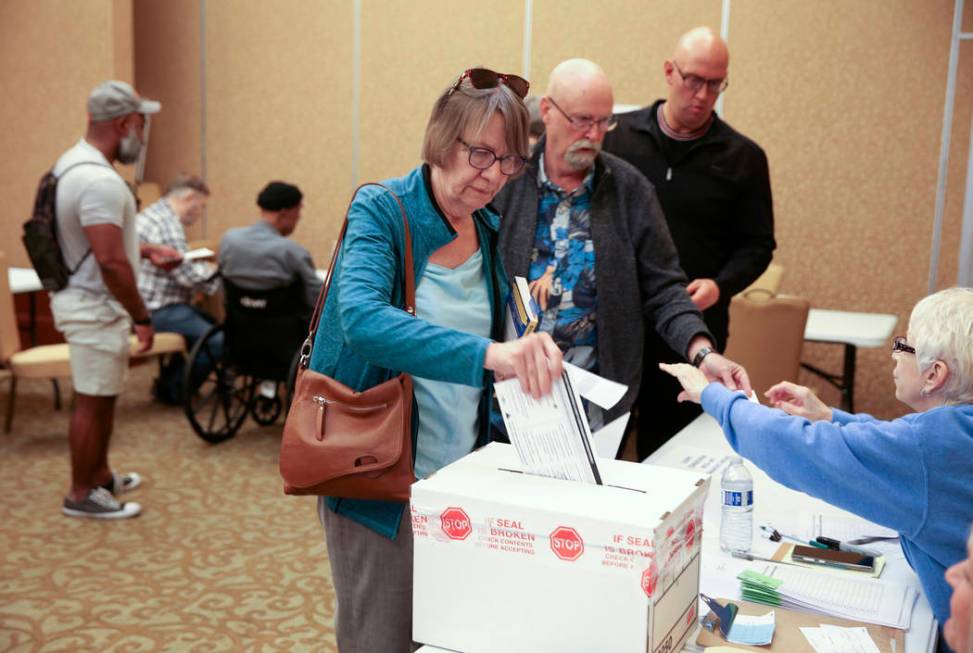 Leslie Doughman, 64, of Henderson, drops her ballot in the box during early voting in the Nevad ...