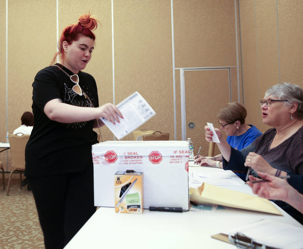 Whitney Vertucci, 27, of Henderson drops her ballot during early voting in the Nevada Democrati ...