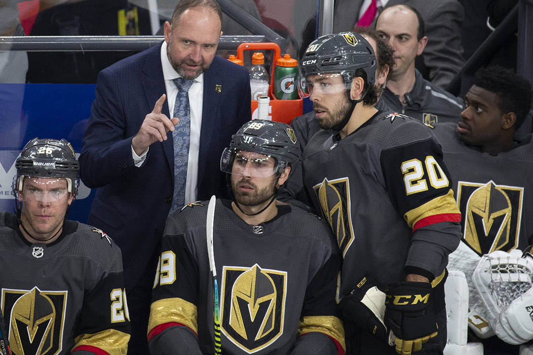 Golden Knights head coach Peter DeBoer talks with Vegas Golden Knights center Chandler Stephens ...